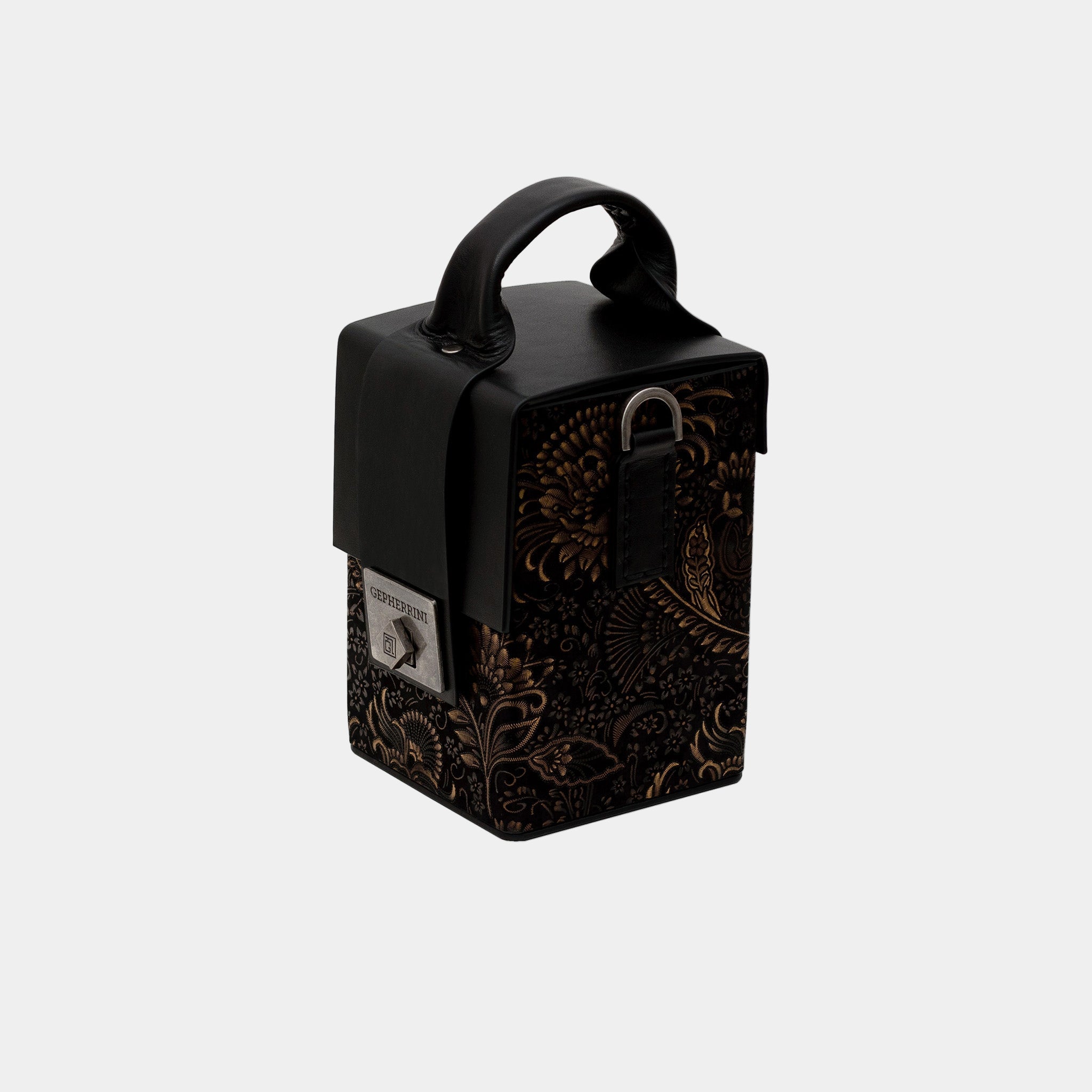 Aneta handbag angled view – sculptural top handle and black floral-embossed leather base