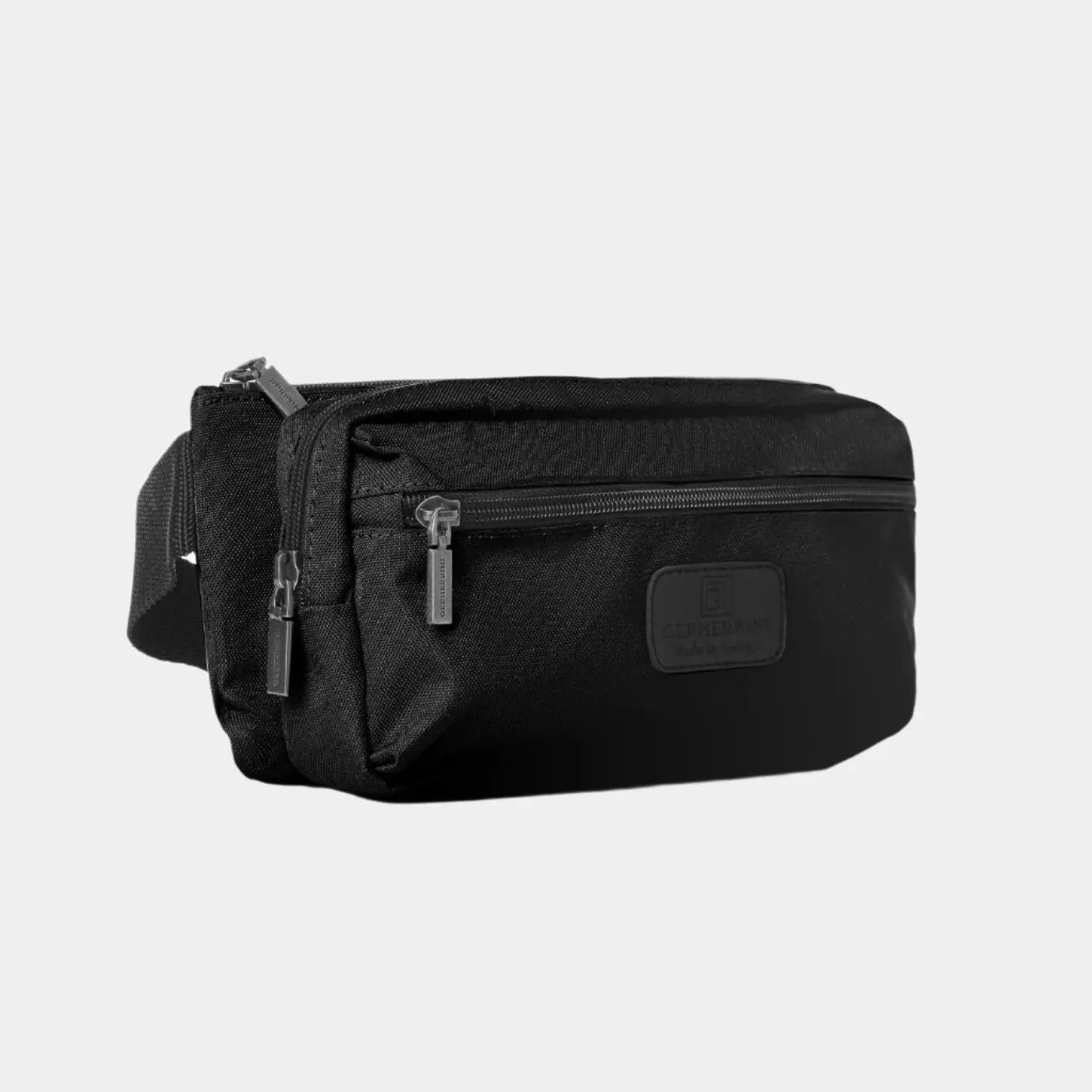 Angled side view of Bellamy black belt bag showing multiple zippered pockets and structured shape
