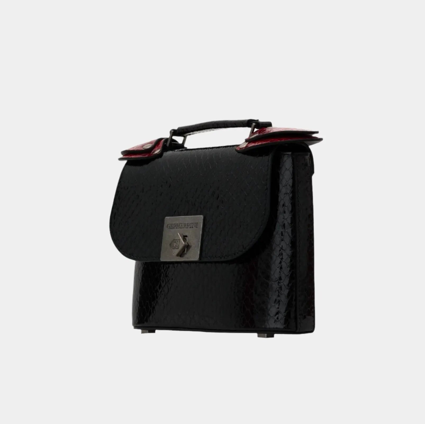 Side profile of Candy handbag showcasing red flap detail, black textured leather, and boxy silhouette