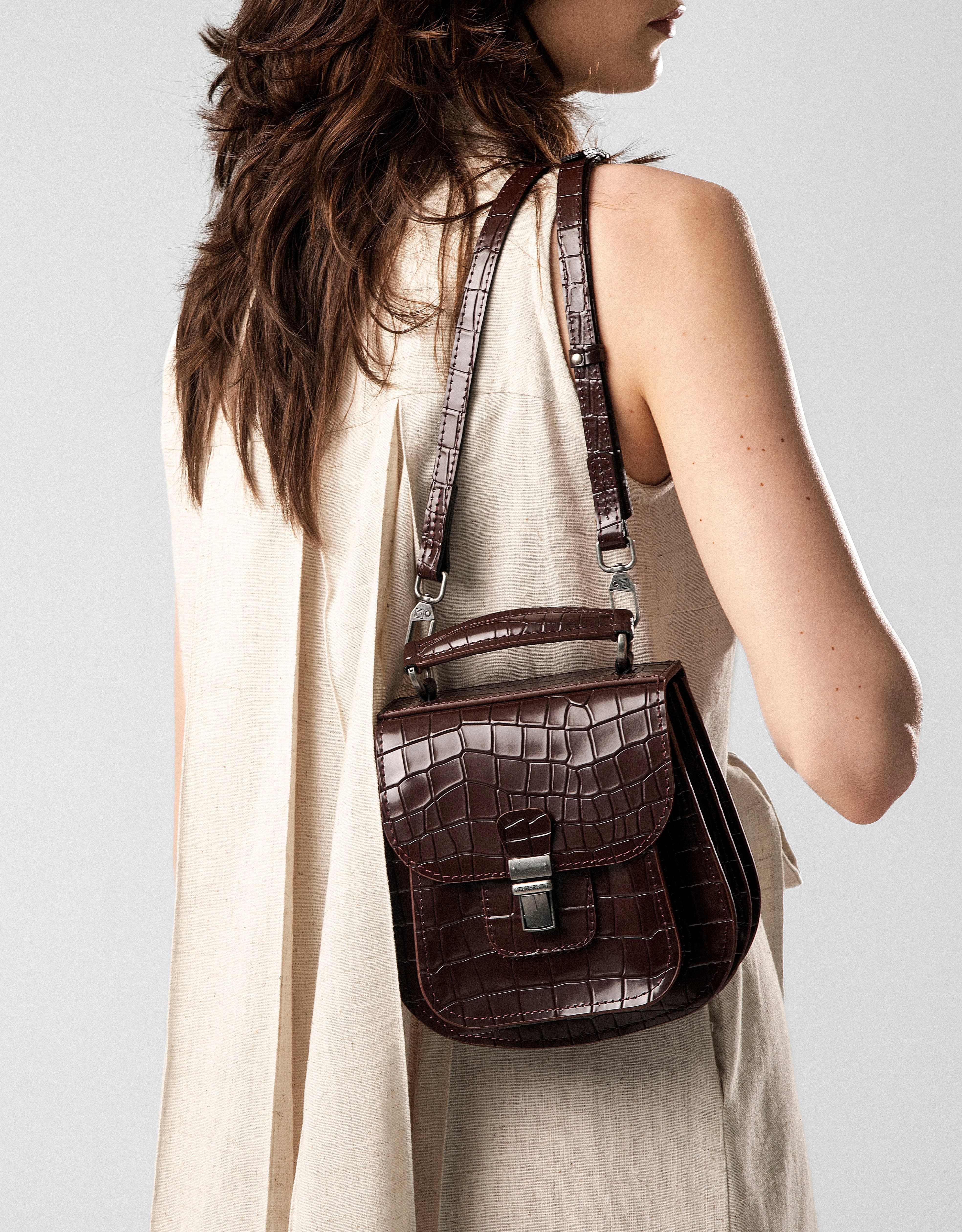 Model wearing Gepherrini Marlow bag in espresso croc-embossed leather