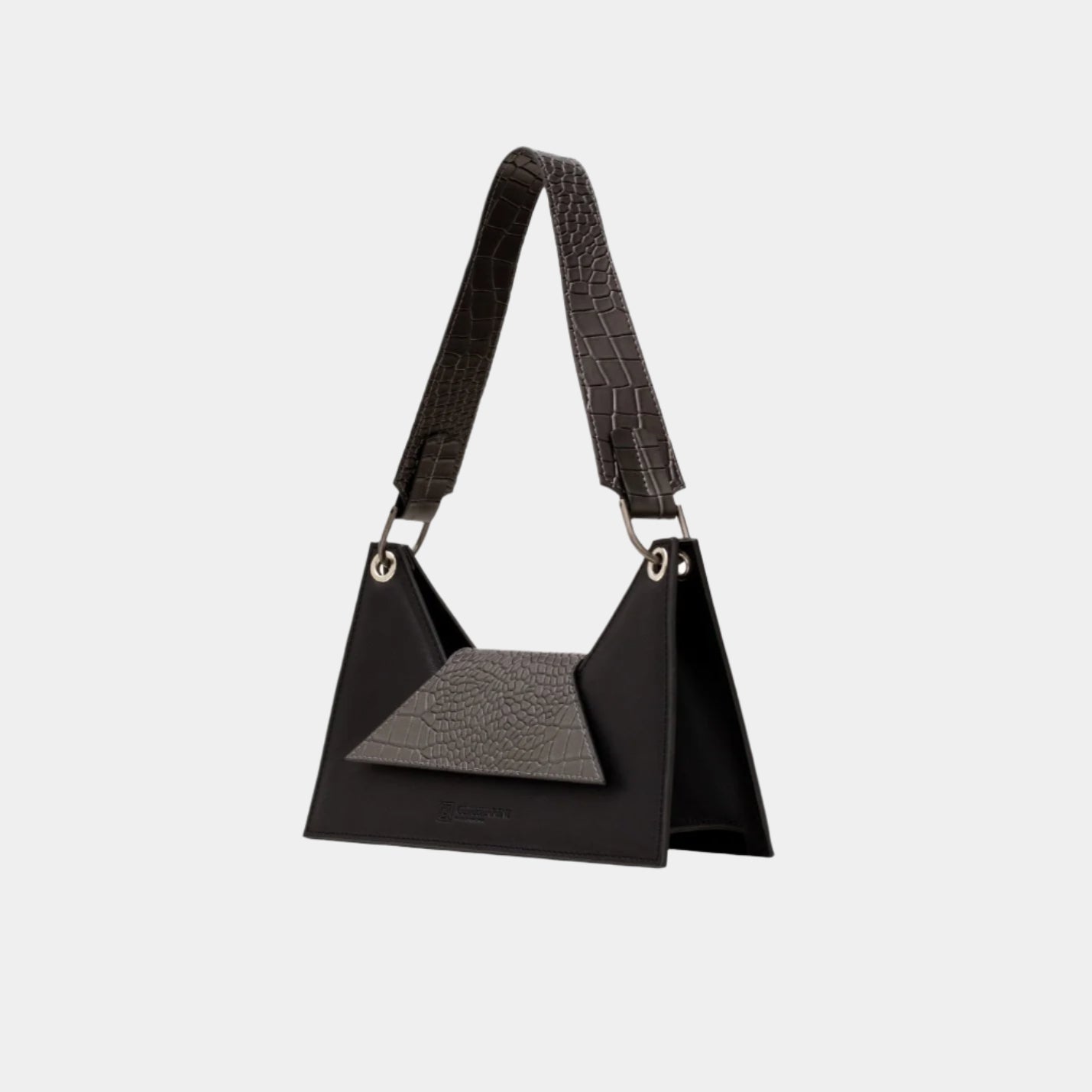 Angled view of Kanna shoulder bag showing sculptural silhouette and textured strap