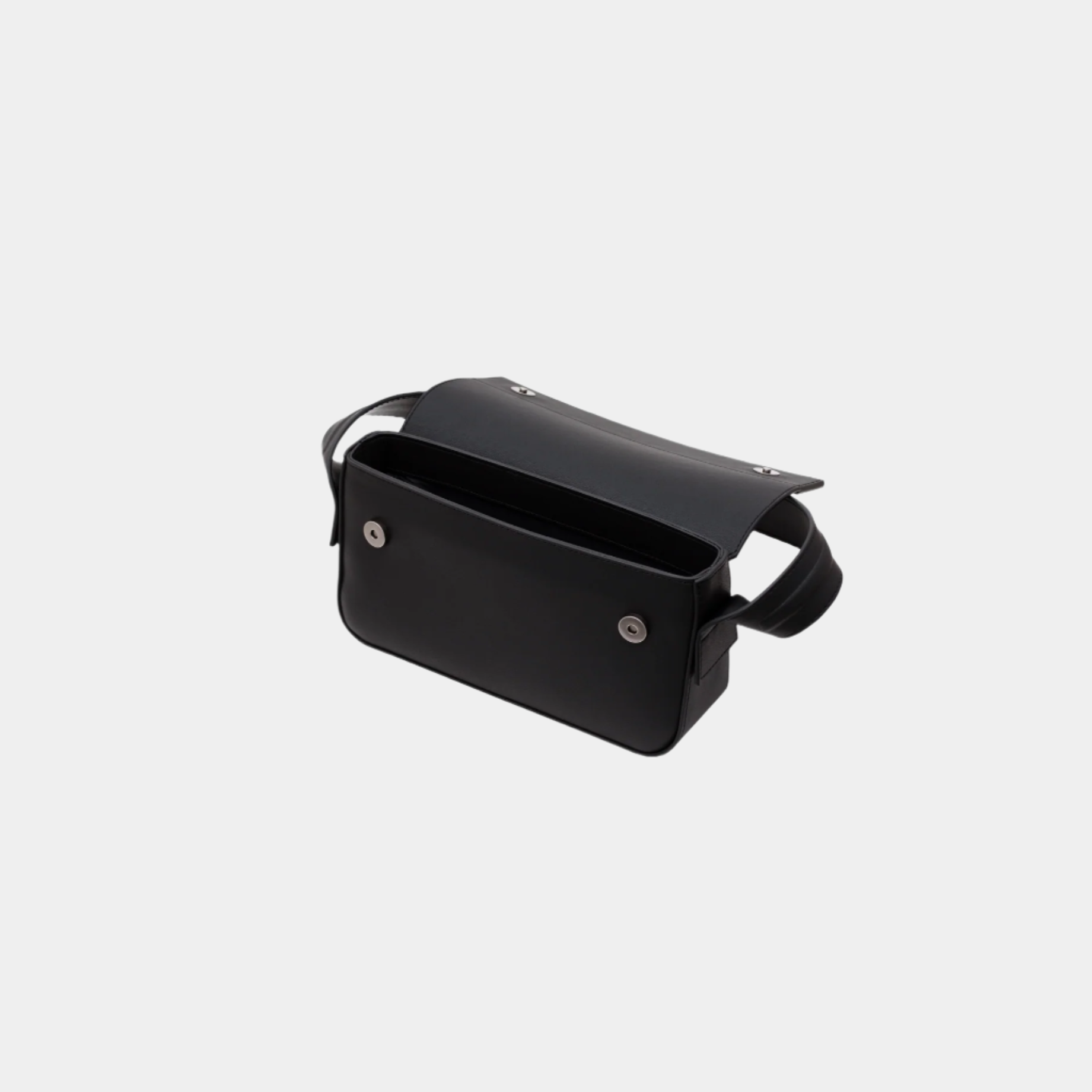 Open view of Thiby black leather handbag showing magnetic closure and spacious interior.